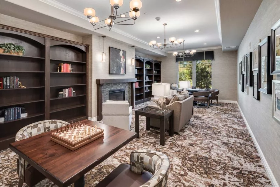 Agoura Hills cozy lounge with sofas, fire place, game tables and book shelves