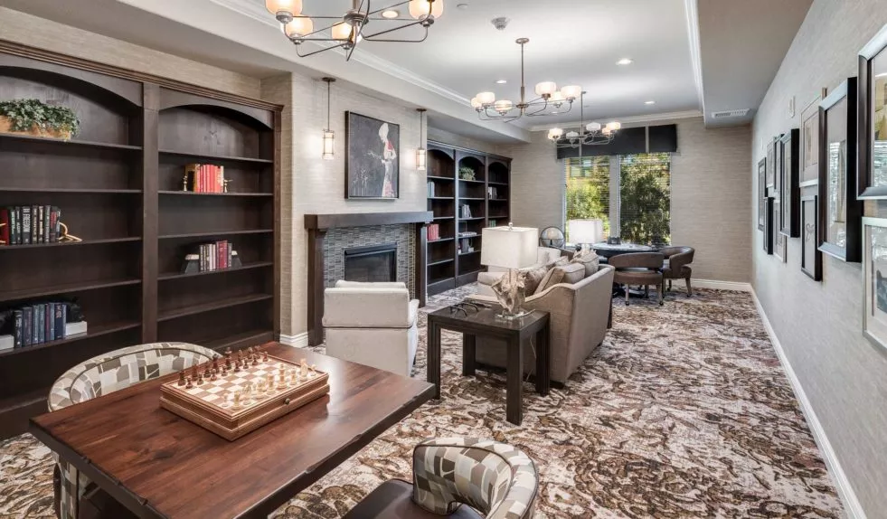 Agoura Hills cozy lounge with sofas, fire place, game tables and book shelves