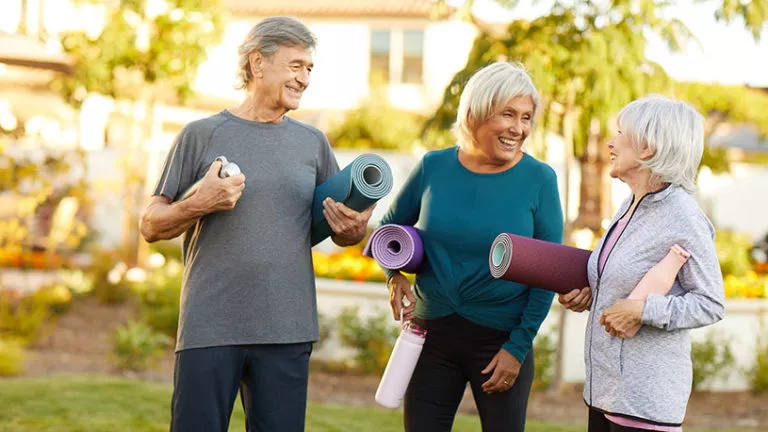 Three people dressed for yoga