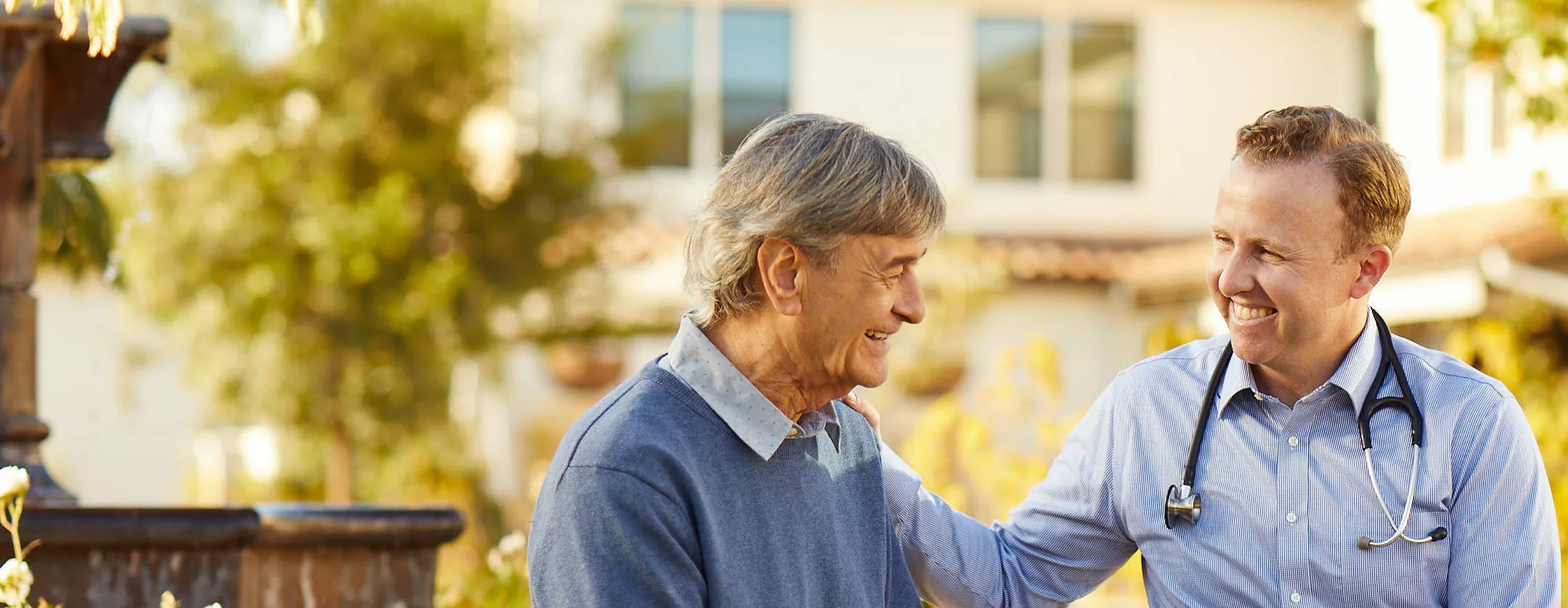 Senior gentleman is talking to a male doctor ourdoors