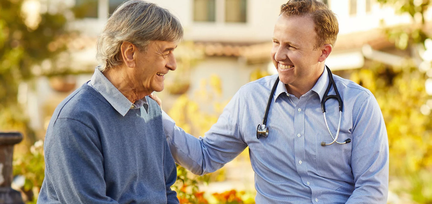 Senior gentleman is talking to a male doctor ourdoors