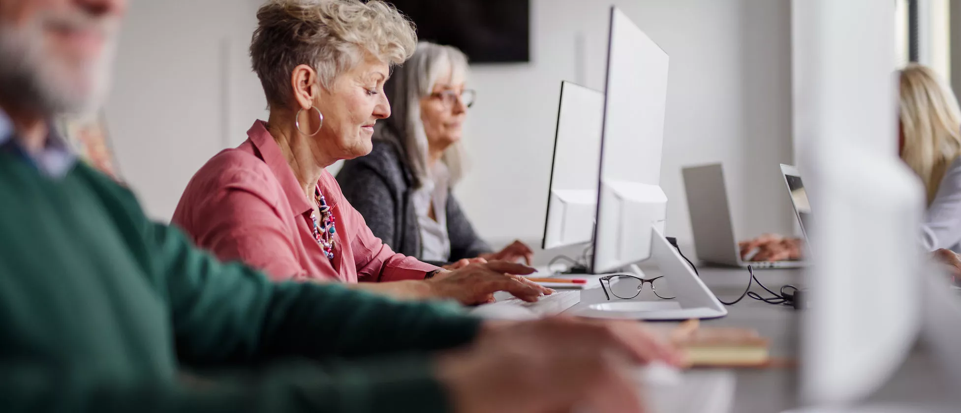 Group of senior people attending computer and technology education class