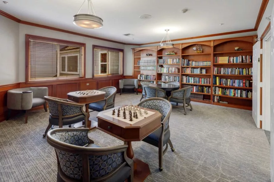 Brookside activity room with chess tables and book shelves