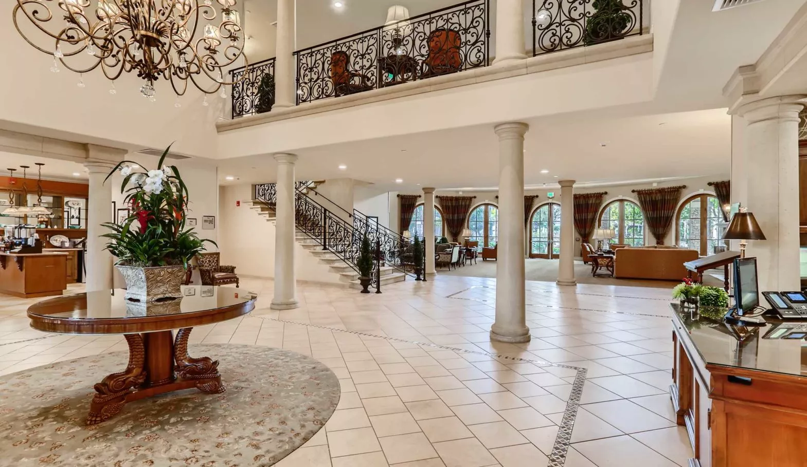 Capriana lobby with big chandelier and table with flowers