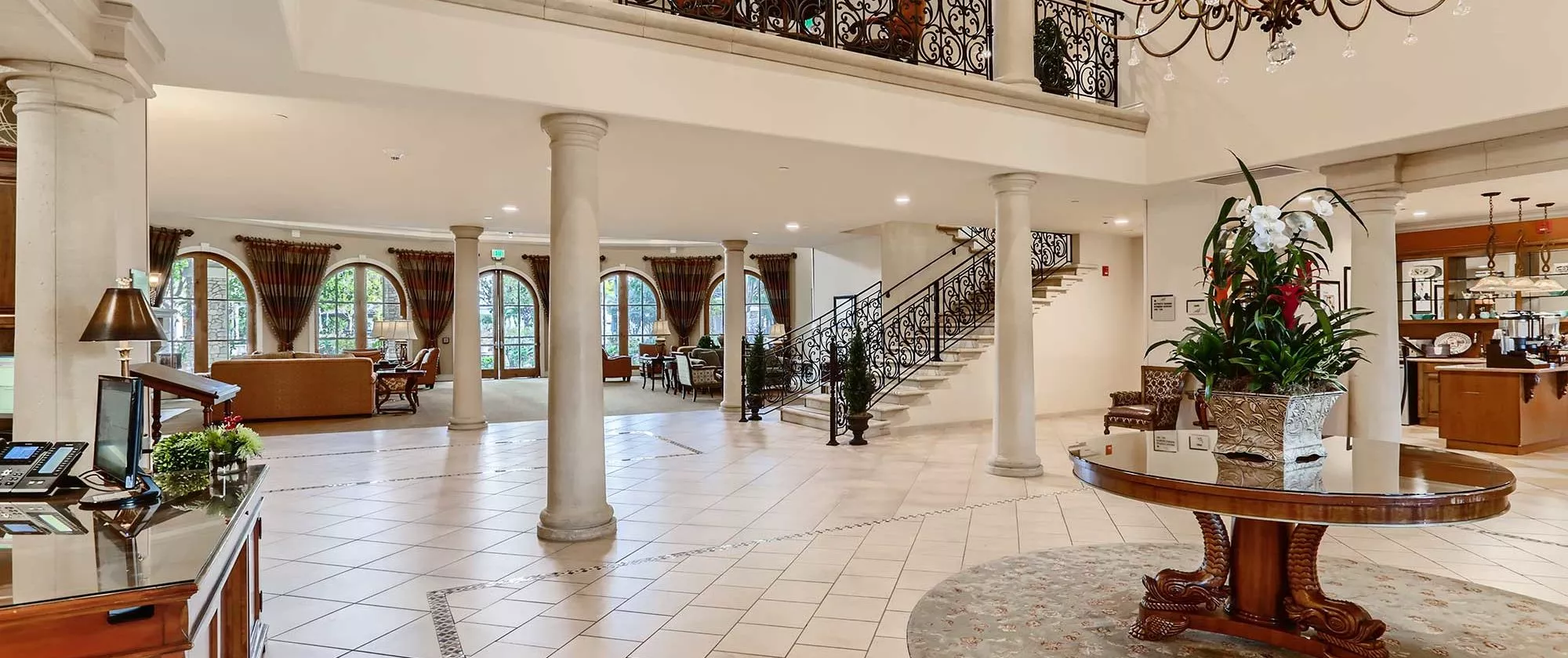 Capriana lobby with big chandelier and table with flowers