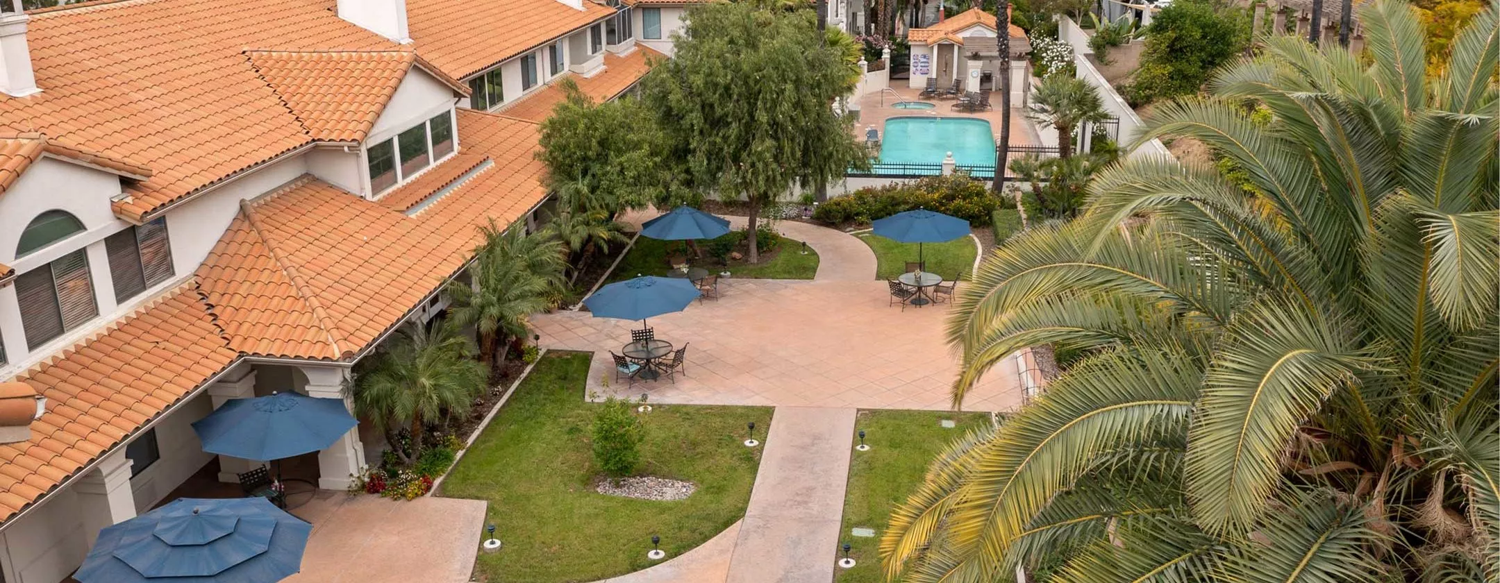 Aerial view of chino hills residence patio with blue umbrellas and pool