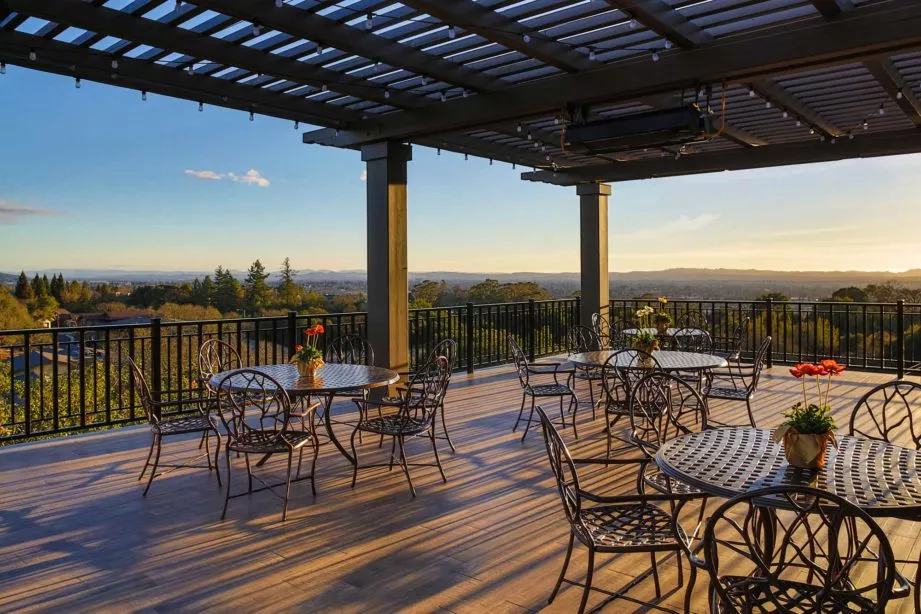 Fountaingrove Lodge covered patio with tables, chairs and beautiful scenic view