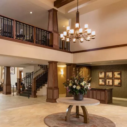 Fountaingrove Lodge entry hall with reception desk, big chandelier and flowers on a table