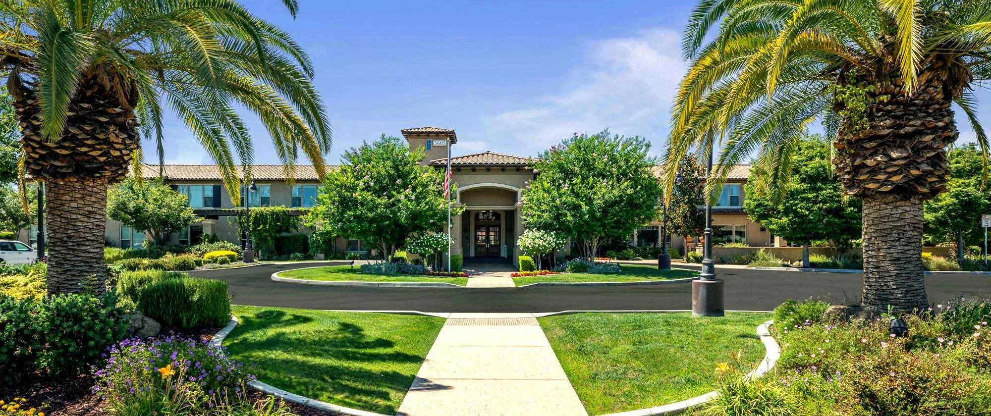Fresno entrance with beautiful gardens and palm trees
