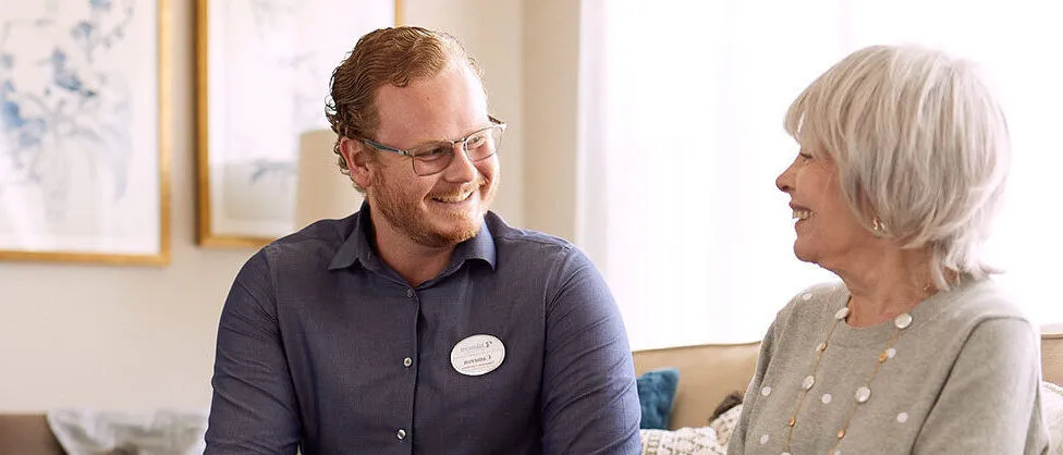 Care giver is speaking to a senior lady
