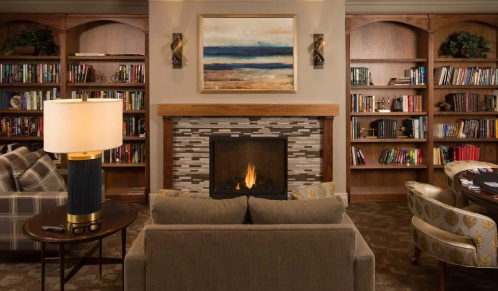 San Jose lounge with sofas, fire place, game table and book shelves