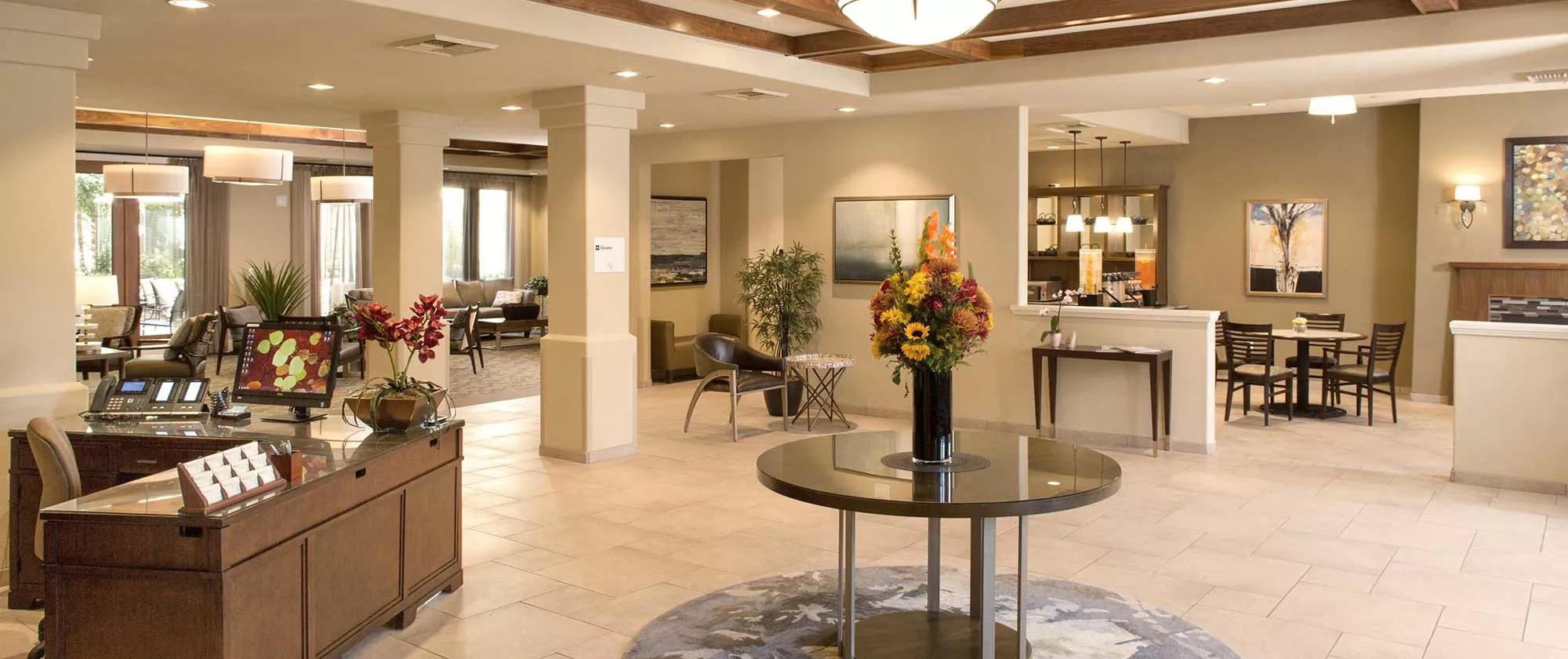 San Jose entry hall with reception desk and a table with flowers