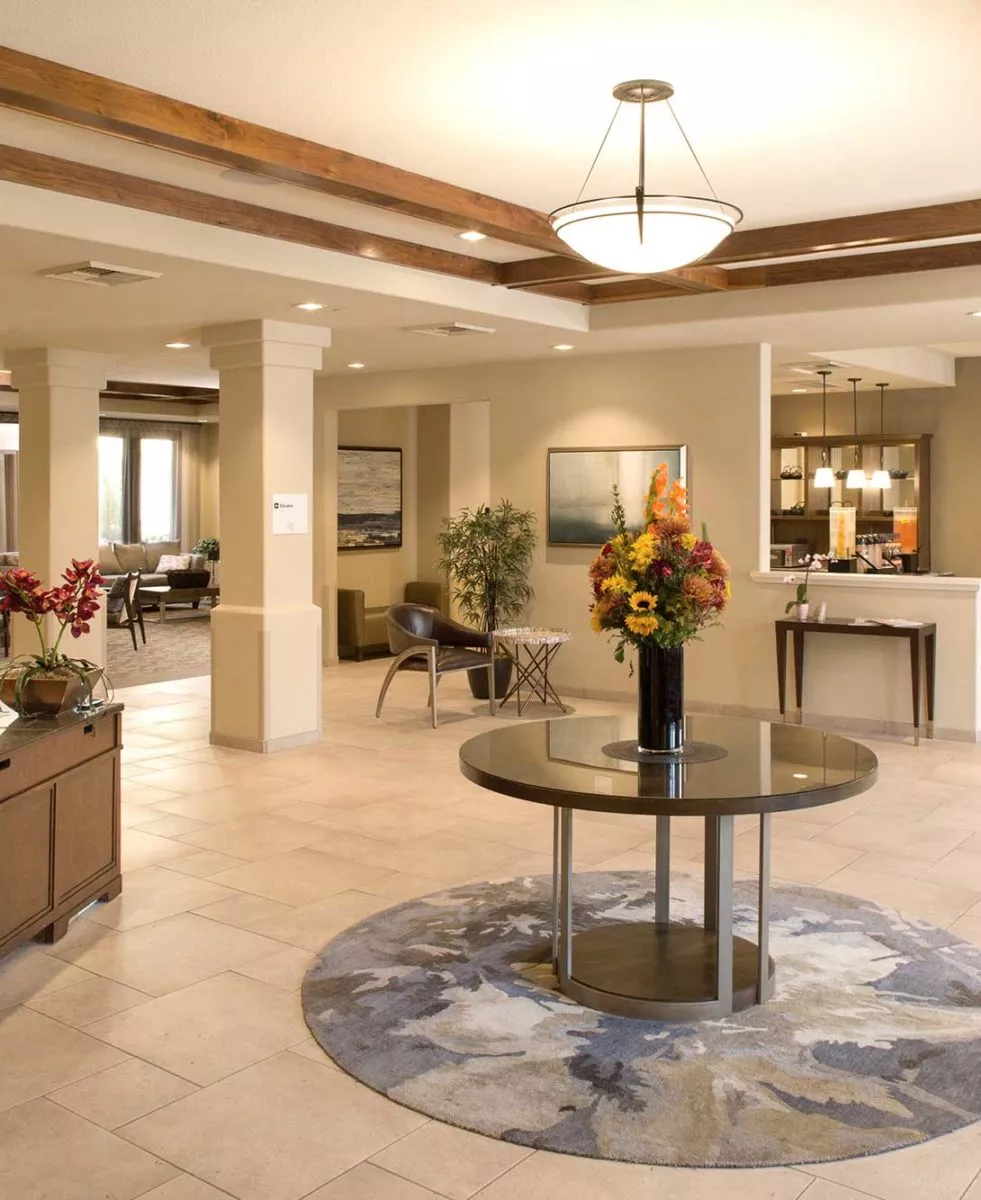 San Jose entry hall with reception desk and a table with flowers