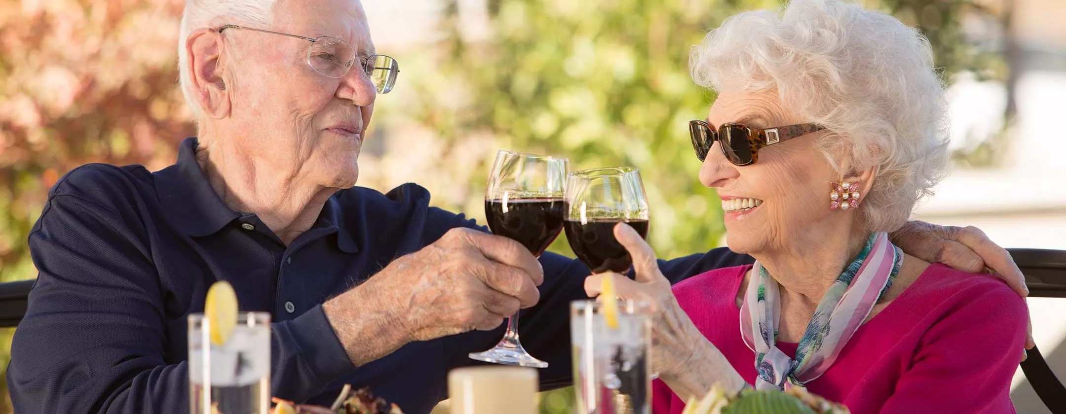 Happy couple having wine outside on patio