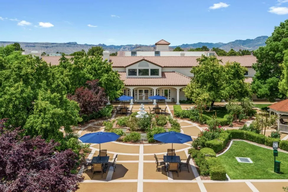 The Lakes aerial view of gardens, patio and fountain in front of building