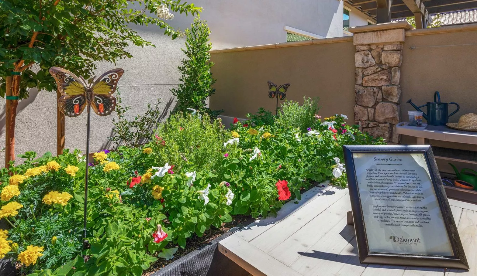 The terraces sensory garden with a planter with flowers and decorative butterflies