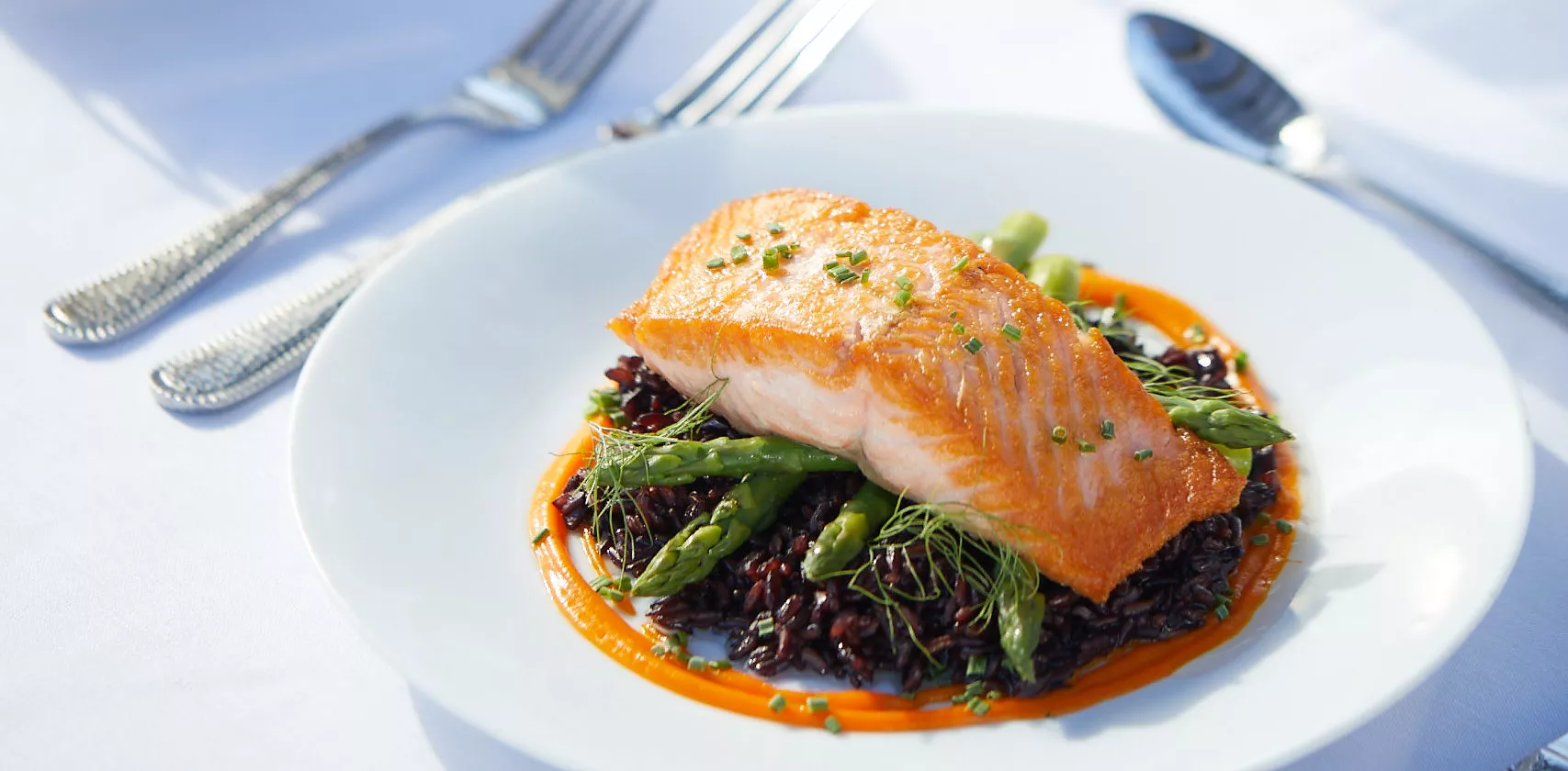 Roasted salmon on the asparagus bed and glass of white wine