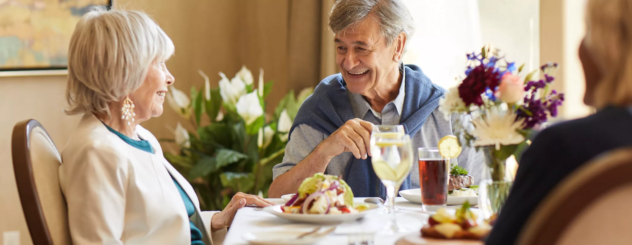 Senior man and woman are talking over the dining table