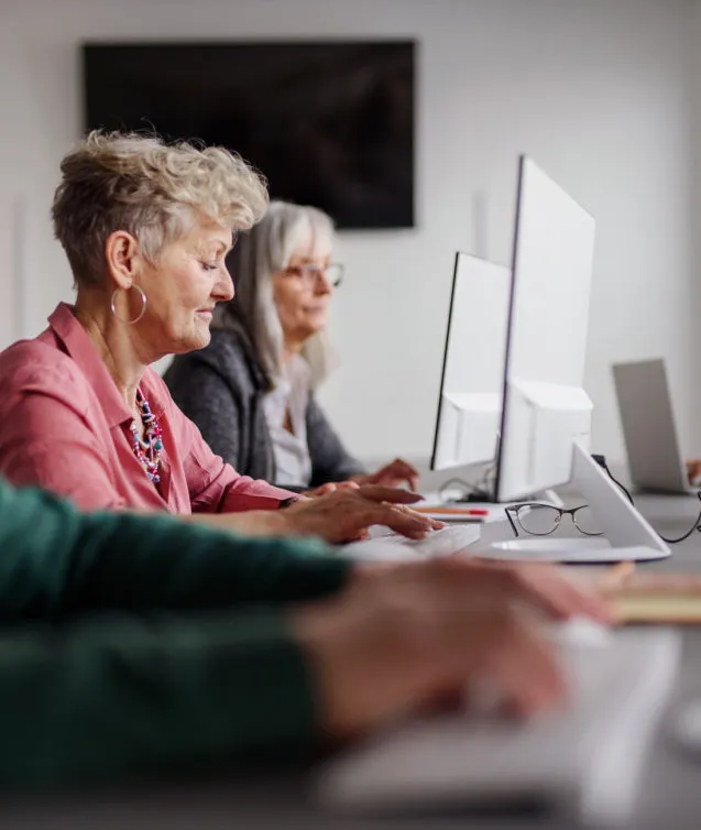 Group of senior people attending computer and technology education class