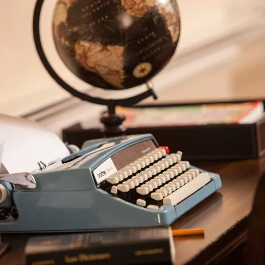 Old typewriter with globe on desk
