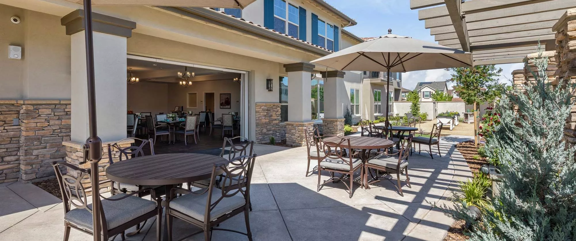 Westpark patio with dining tables and chairs and umbrellas