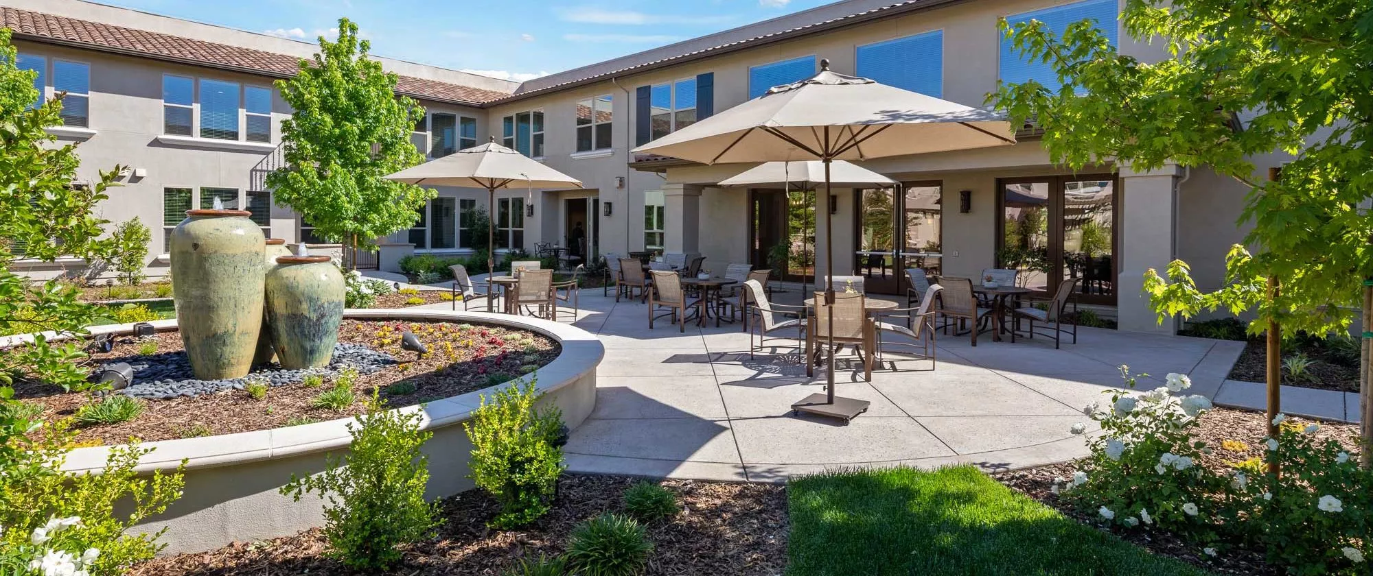 Westpark patio with fountains, dining tables, chairs and umbrellas