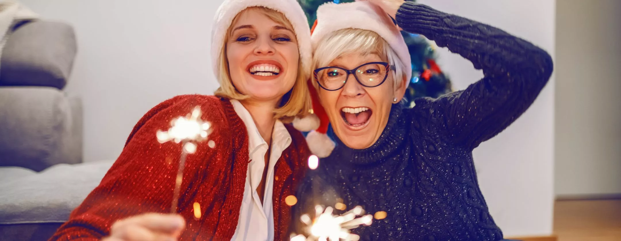 Senior woman taking Christmas photo with daughter