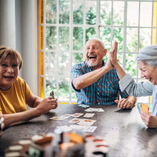 Senior people playing cards in nursing home