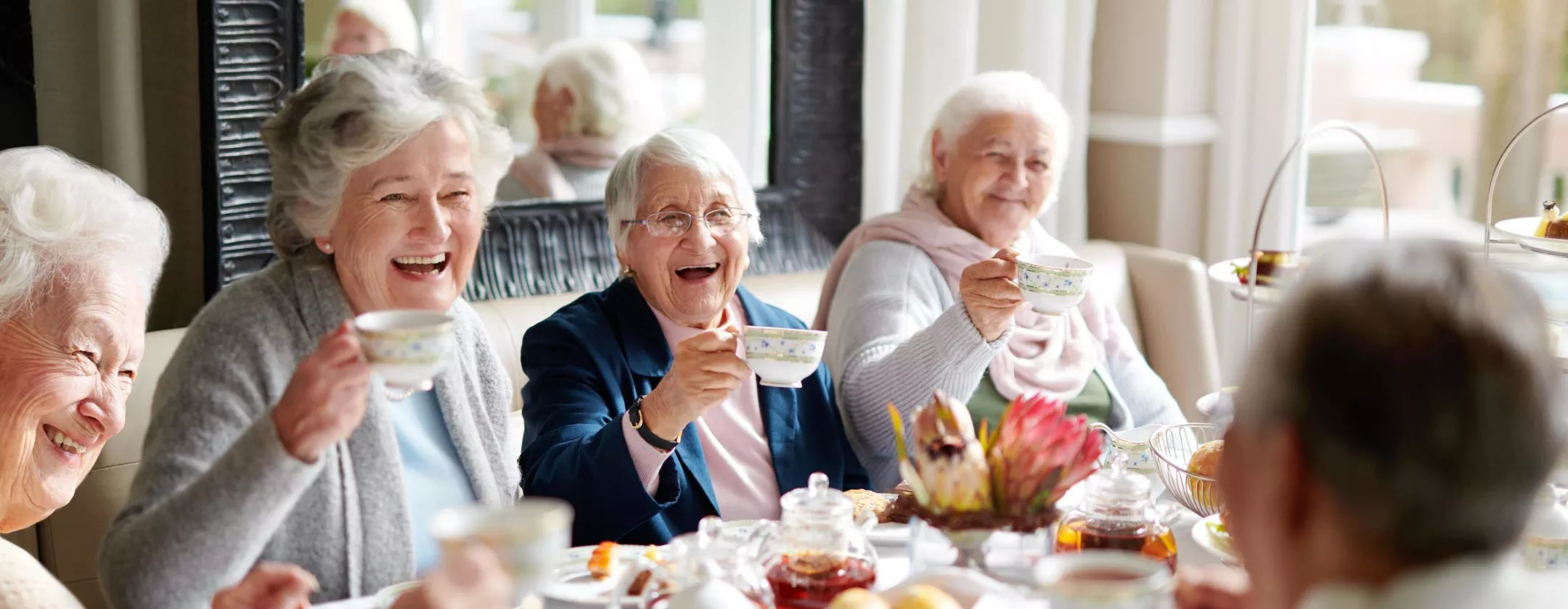 Senior women laughing at tea party