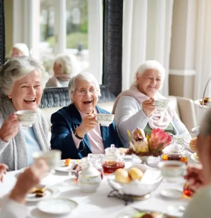 Senior women laughing at tea party